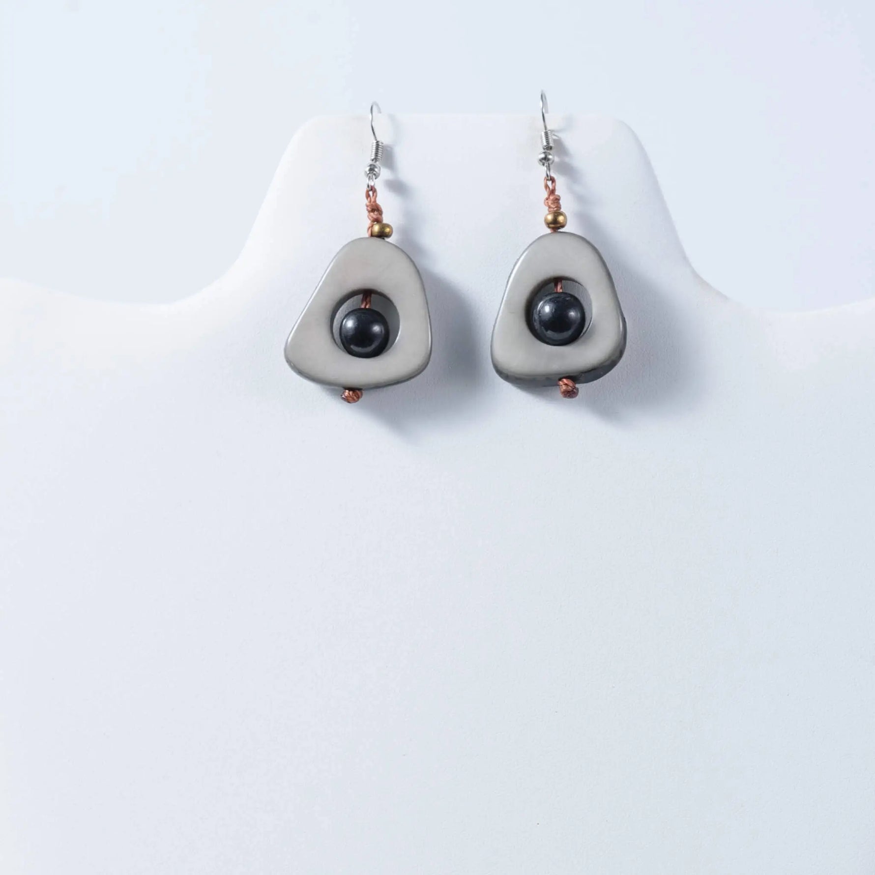 Gray teardrop eco friendly tagua earrings with central black bead and copper accents perfect for everyday wear