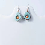 Eden tear-drop eco-friendly tagua earrings in light blue avocado shape with orange centers and copper accents