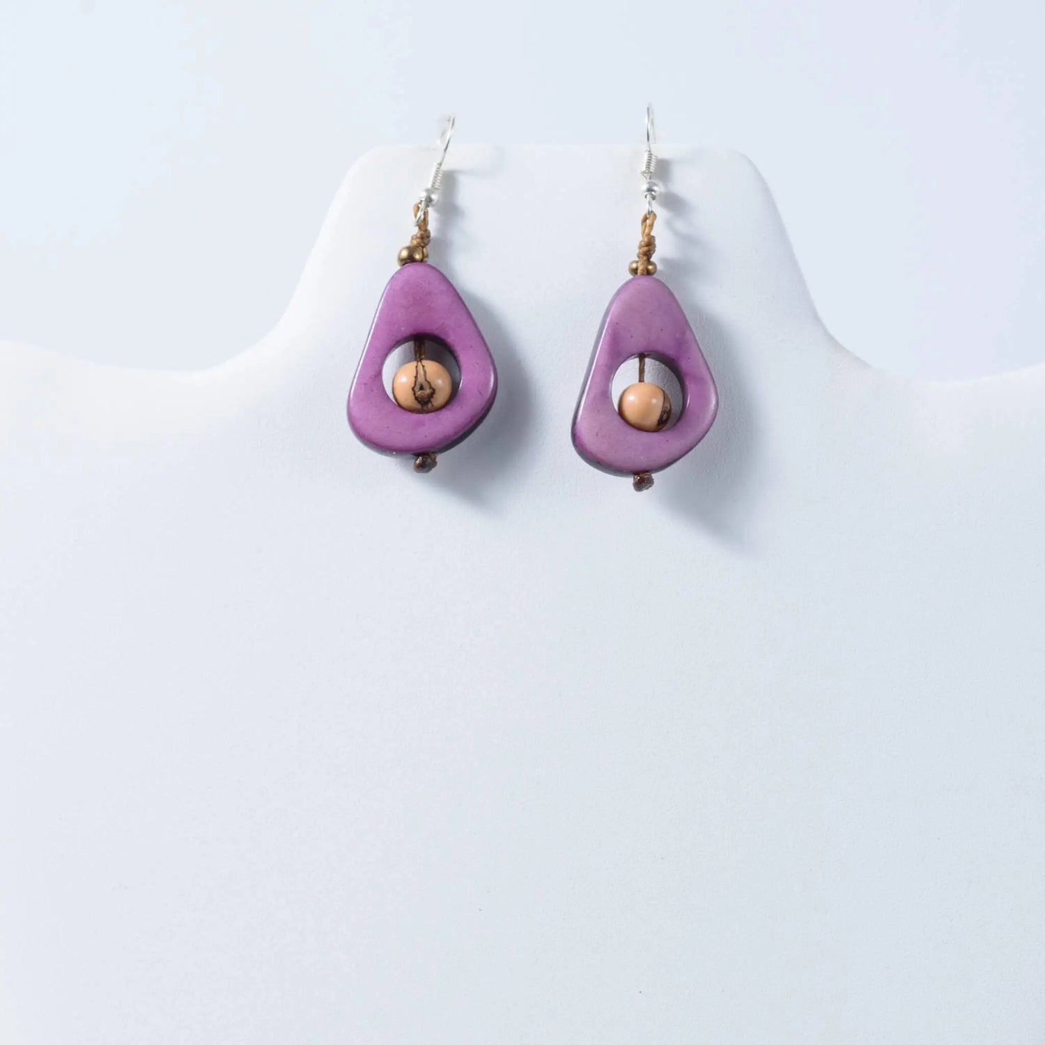 Purple teardrop eco friendly tagua earrings with a central wooden bead and silver hooks for everyday wear