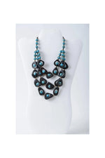 Eden three stranded tagua necklace set with bold black teardrop beads and turquoise pearls in a layered design