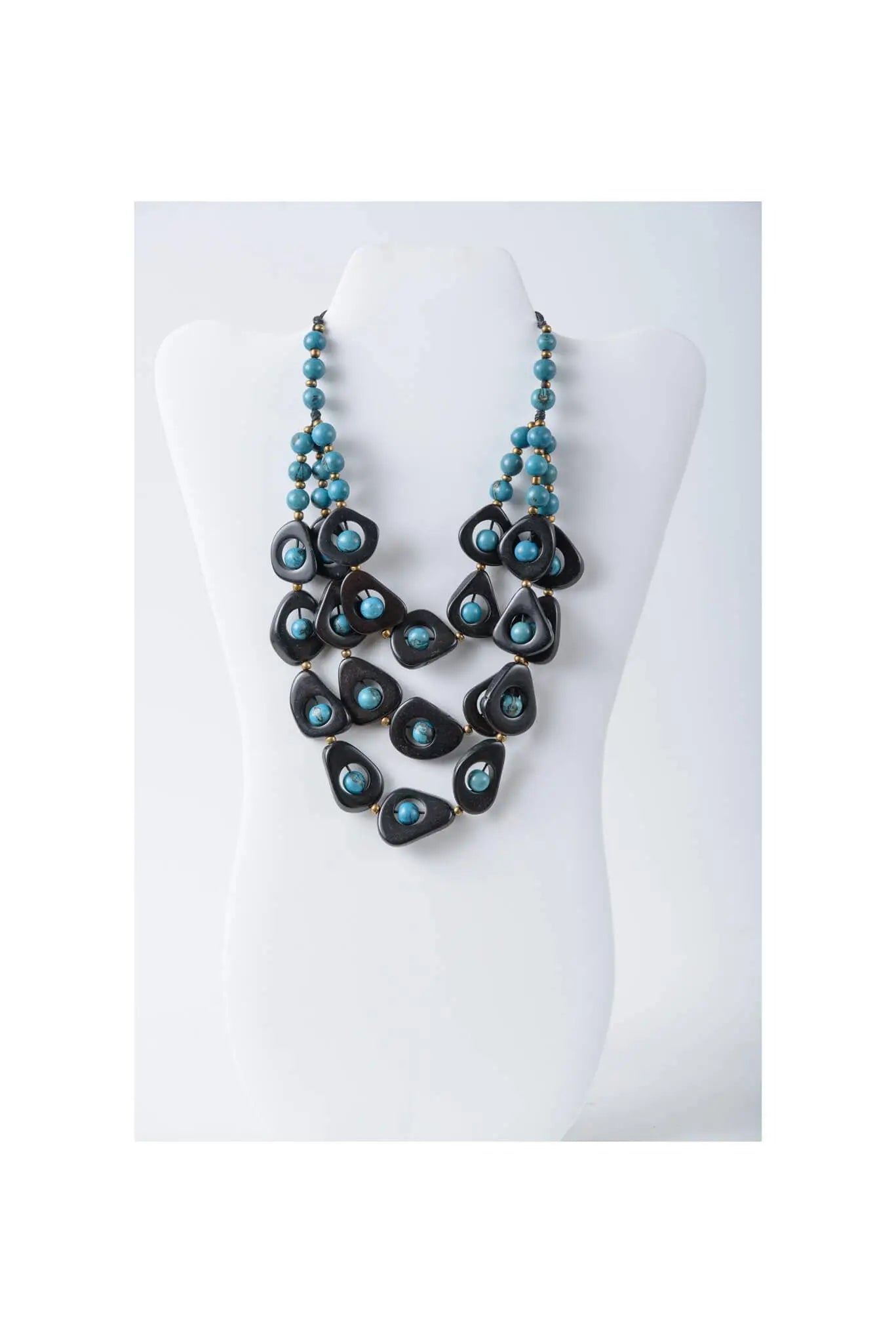 Eden three stranded tagua necklace set with bold black teardrop beads and turquoise pearls in a layered design
