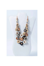 Eden three stranded tagua necklace with earth toned ceramic pendants in beige brown black and gray with metallic accents