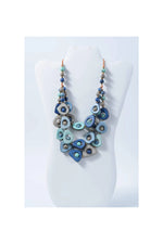 Eden three stranded tagua necklace with glossy blue and teal ceramic-like pendants on copper-toned chains