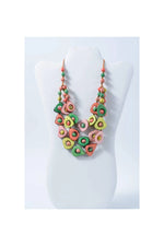 Eden three stranded tagua necklace with vibrant pastel triangular beads in pink green and yellow accented with metallic details