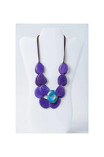 Purple teardrop beads with turquoise accent in a layered tagua slice necklace from the Ella collection