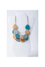 Ella layered tagua slice necklace with teal light blue and tan teardrop beads on braided copper cord layered tagua slice