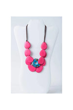 Ella layered tagua slice necklace with vibrant fuchsia heart beads on dark brown cord and turquoise tagua slice accent
