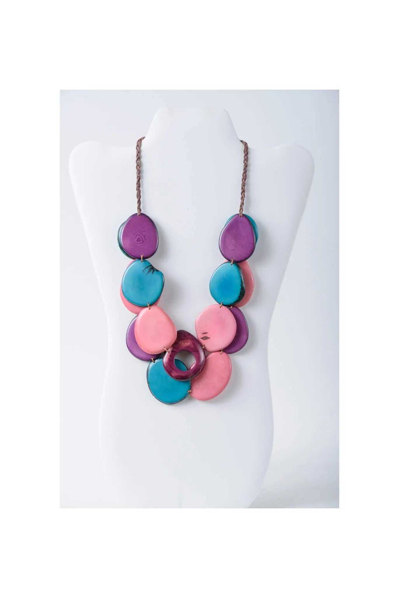 Vibrant layered tagua slice necklace with glossy purple teal and pink irregular beads on braided brown cord