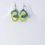 Fern interlocking tagua earrings with green and lime green glossy rings made from sustainable tagua material