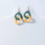 Green and yellow abstract ring earrings with glossy resin finish from fern interlocking tagua earrings collection
