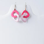 Fern interlocking tagua earrings with pink and light pink rings and silver hooks made from natural tagua material