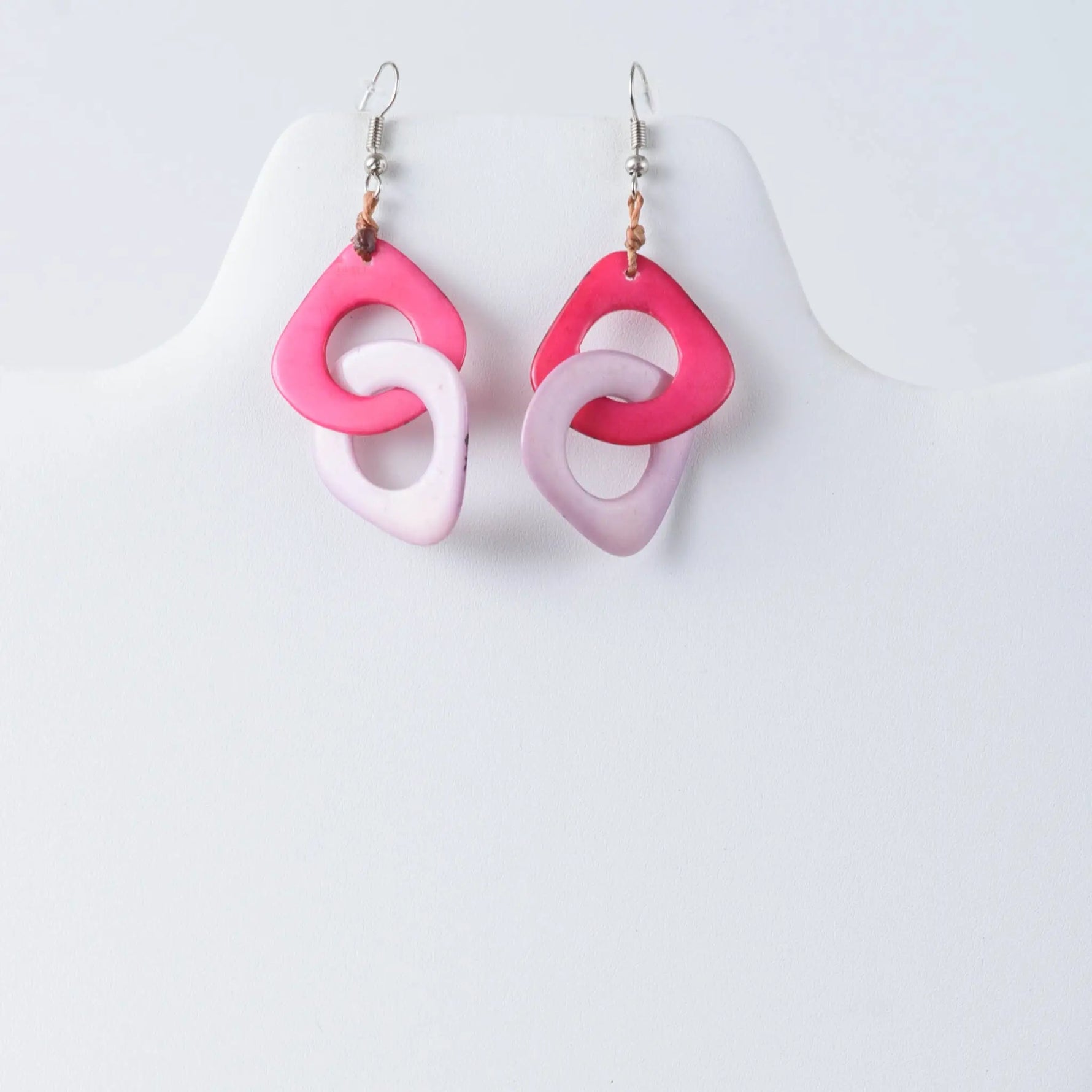 Fern interlocking tagua earrings with pink and light pink rings and silver hooks made from natural tagua material