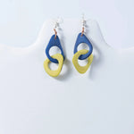 Fern interlocking tagua earrings with blue and yellow geometric drop design made from natural tagua material
