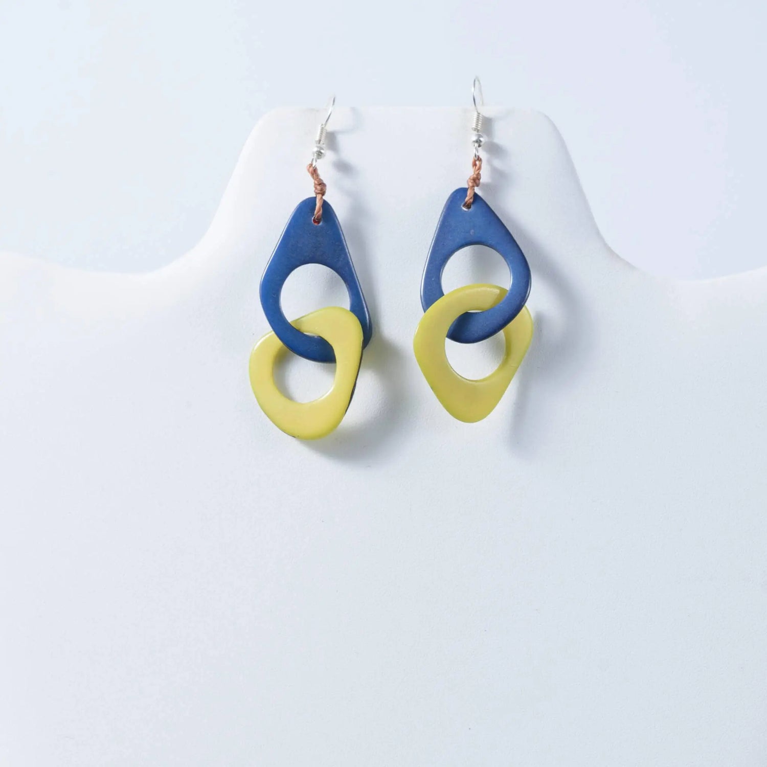 Fern interlocking tagua earrings with blue and yellow geometric drop design made from natural tagua material