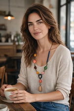 Flattering y shape jacinta necklace with asymmetrical design and central drop tagua nuts in orange pink green and blue beads
