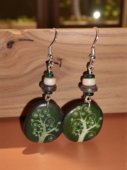 Forest green tree-of-life pendant earrings with silver hooks and layered tags made from laser engraved tagua slices