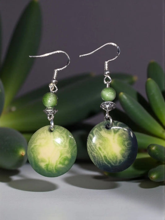 Forest green tagua round disc earrings with green gradient resin dangles silver hooks and small green bead plastic-free and vegan