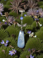A gorgeous blue tagua nut necklace with a silver dragonfly pendant featuring fair trade lightweight jewelry gift stones