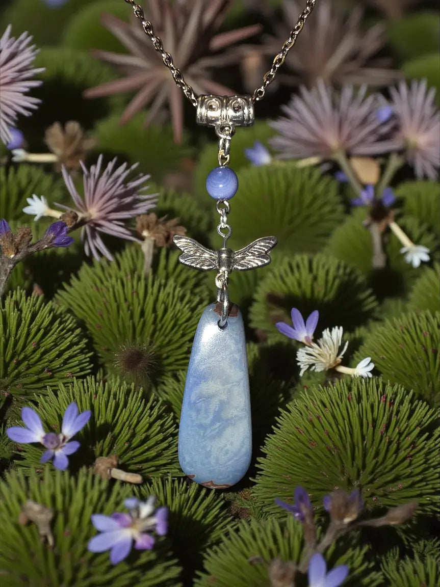 A gorgeous blue tagua nut necklace with a silver dragonfly pendant featuring fair trade lightweight jewelry gift stones