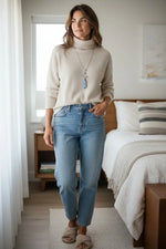 Beige turtleneck sweater with ribbed cuffs and neckline paired with a gorgeous blue tagua nut dragonfly necklace fair trade jewelry gift