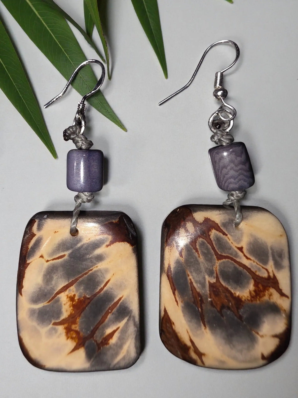 Rectangular marbled brown and cream tagua earrings with purple beads and silver hooks from gray matter natural marble slice collection