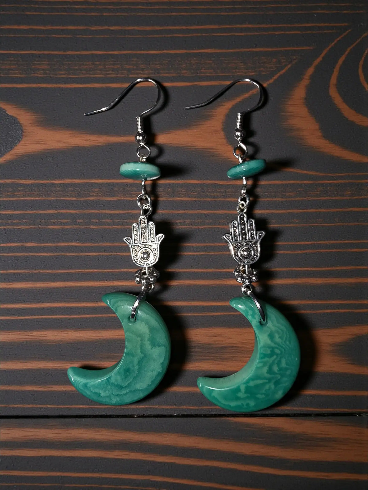 Teal green moon carved tagua nut earrings with silver hamsa hand charms and small turquoise beads