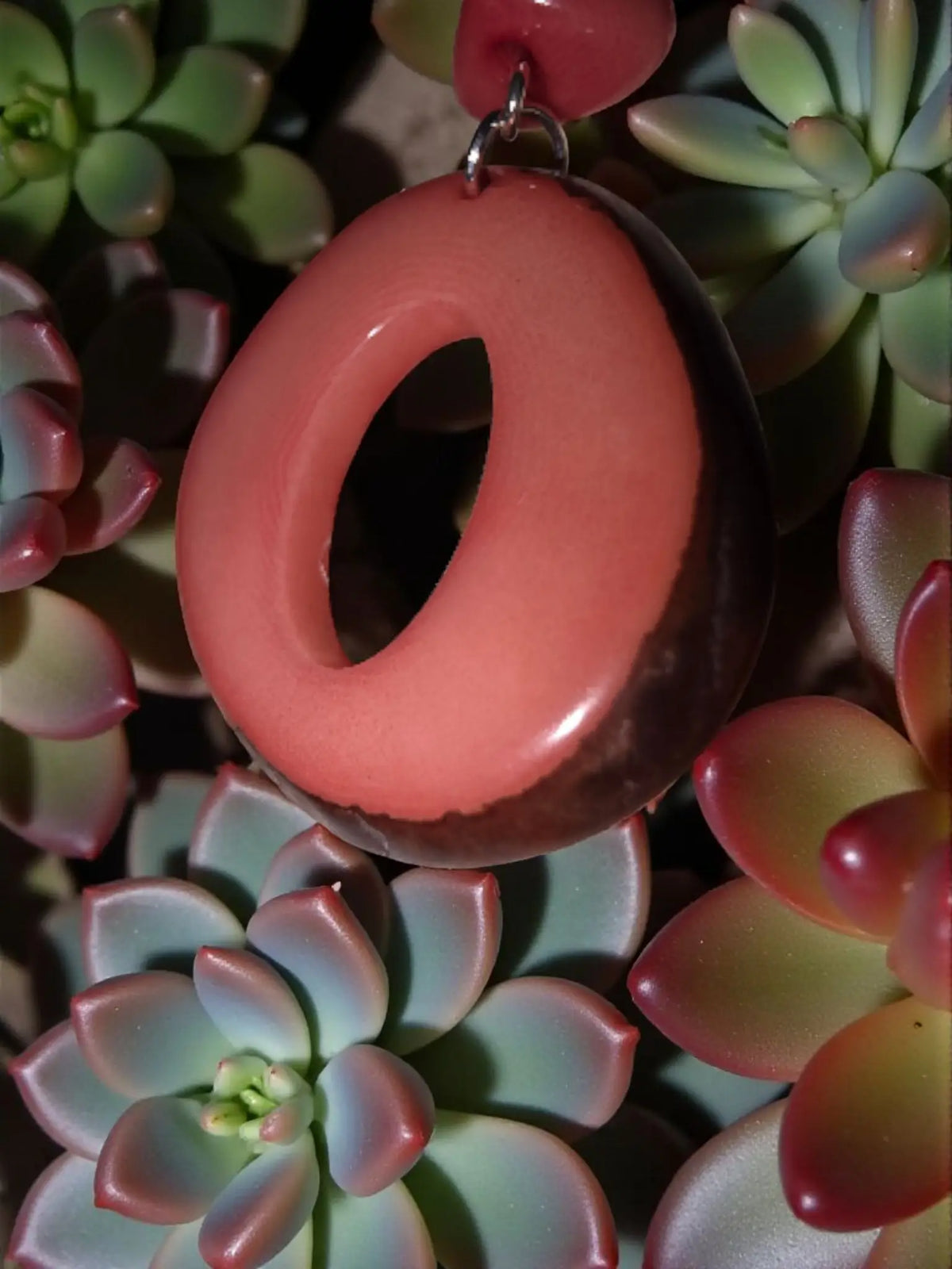 Handmade natural donut cut fair trade tagua hoop earring in glossy salmon pink and dark brown with polished finish