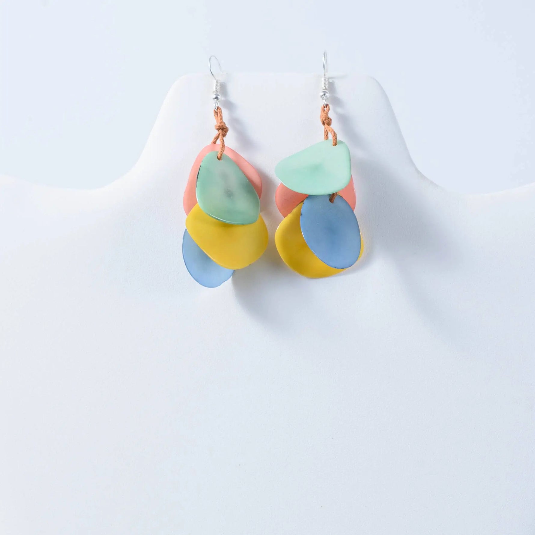 Pastel-colored layered disc tagua nut earrings with a playful modern design in the holly curved petal style