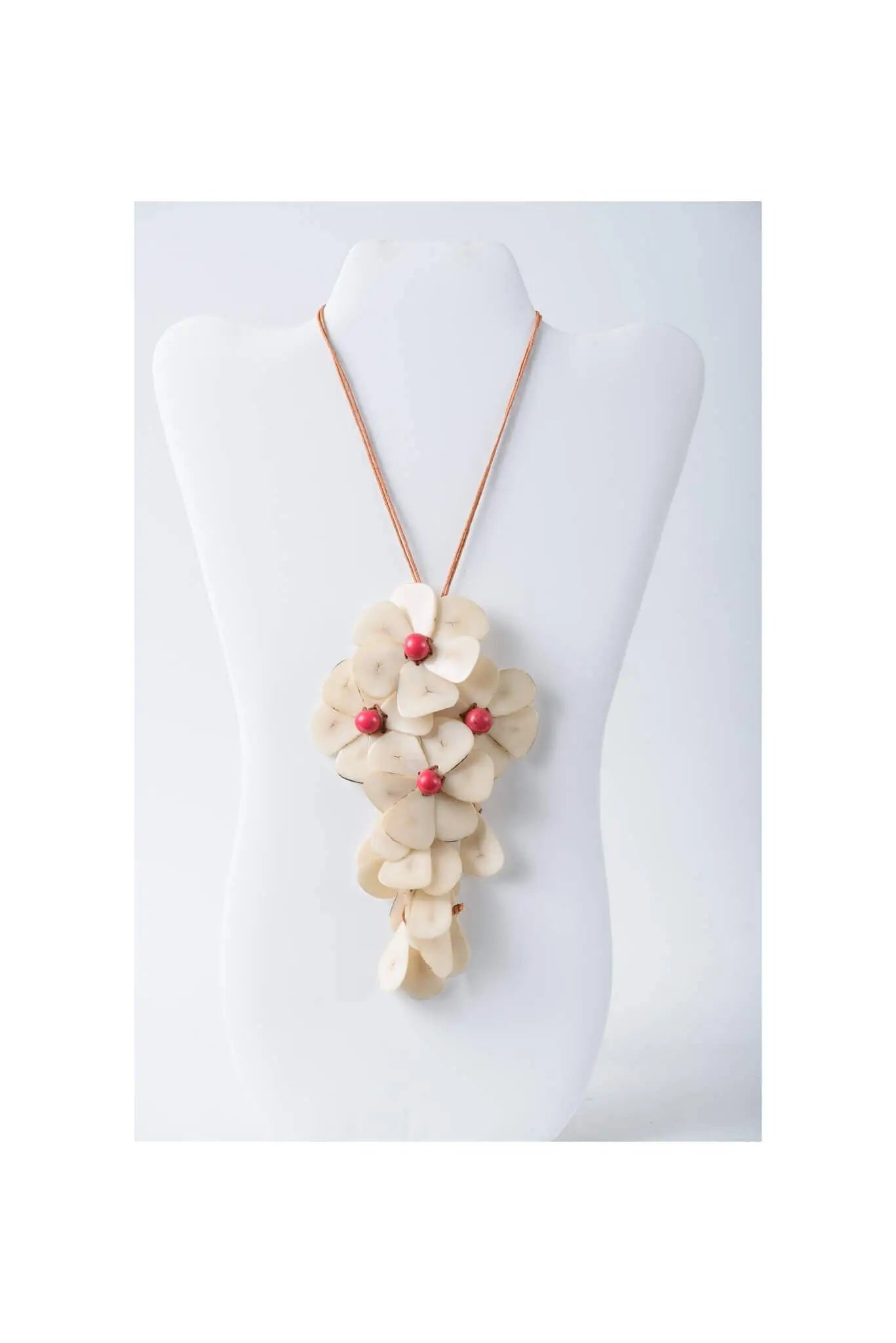 Beige holly pendant flower tagua necklace with delicate layered petals and small red beads in fuchsia style