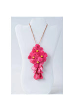 Vibrant fuchsia holly pendant flower tagua necklace with layered petals and gold centers on a delicate gold-toned chain
