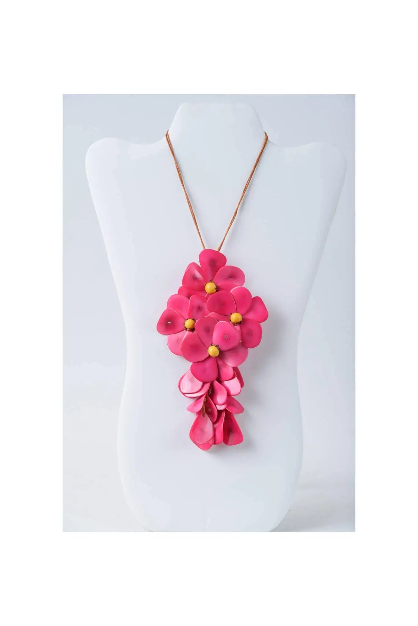 Vibrant fuchsia holly pendant flower tagua necklace with layered petals and gold centers on a delicate gold-toned chain