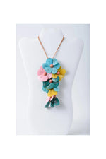 Holly pendant flower tagua necklace with vibrant blue pink and yellow layered petals on a copper-toned chain