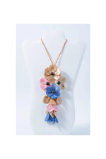 Holly pendant flower tagua necklace with colorful layered blossoms in pink blue and beige tones