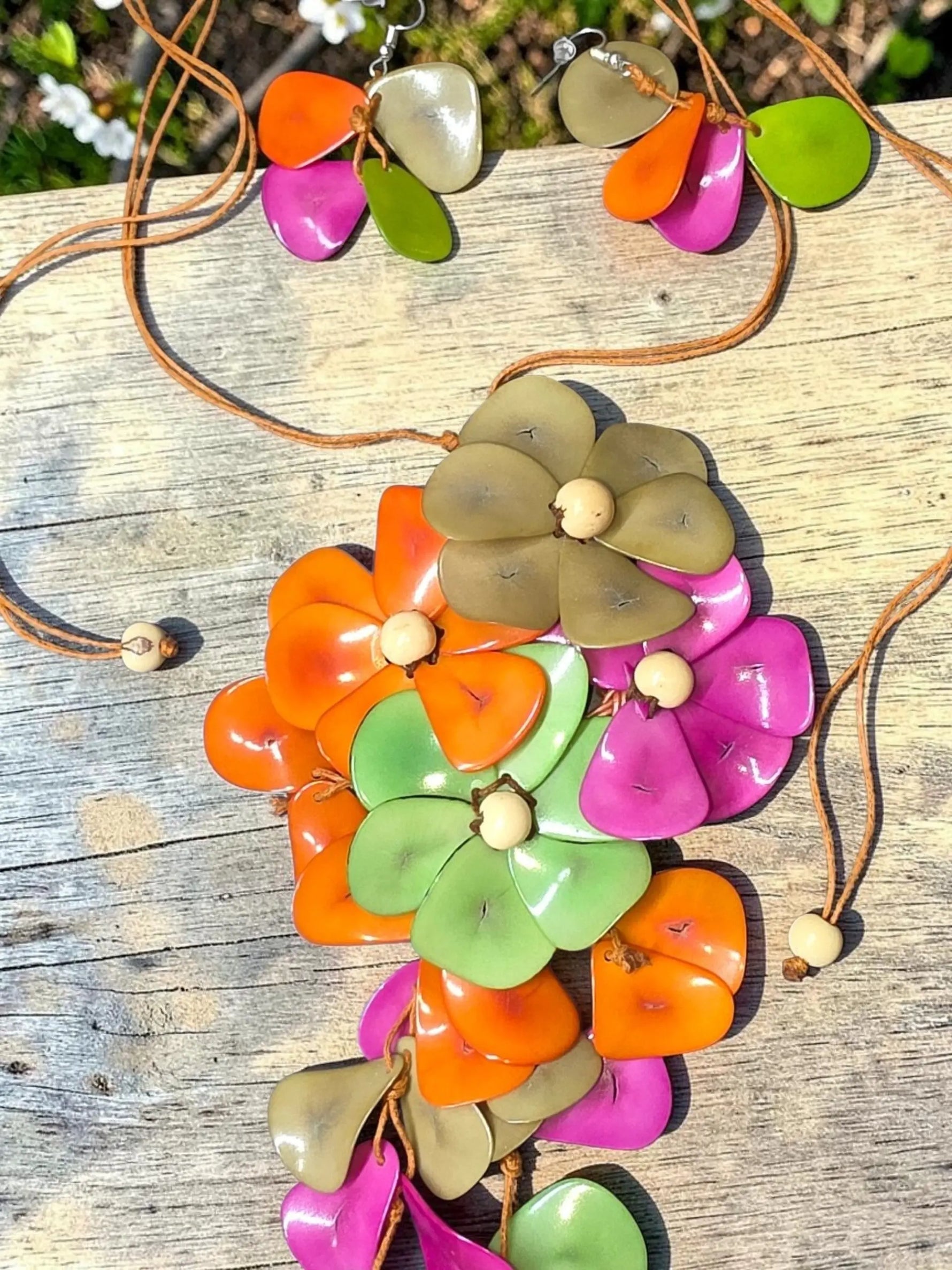Vibrant holly pendant flower tagua necklace with glossy layered petals in orange pink green and beige tones