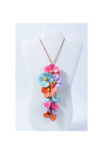 A vibrant holly pendant flower tagua necklace with layered pink blue orange and purple petals