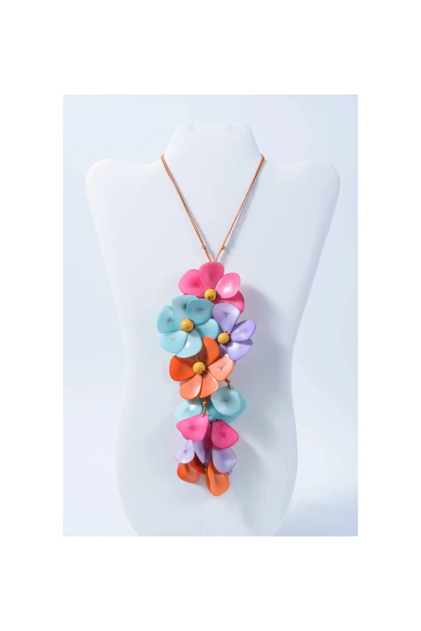 A vibrant holly pendant flower tagua necklace with layered pink blue orange and purple petals