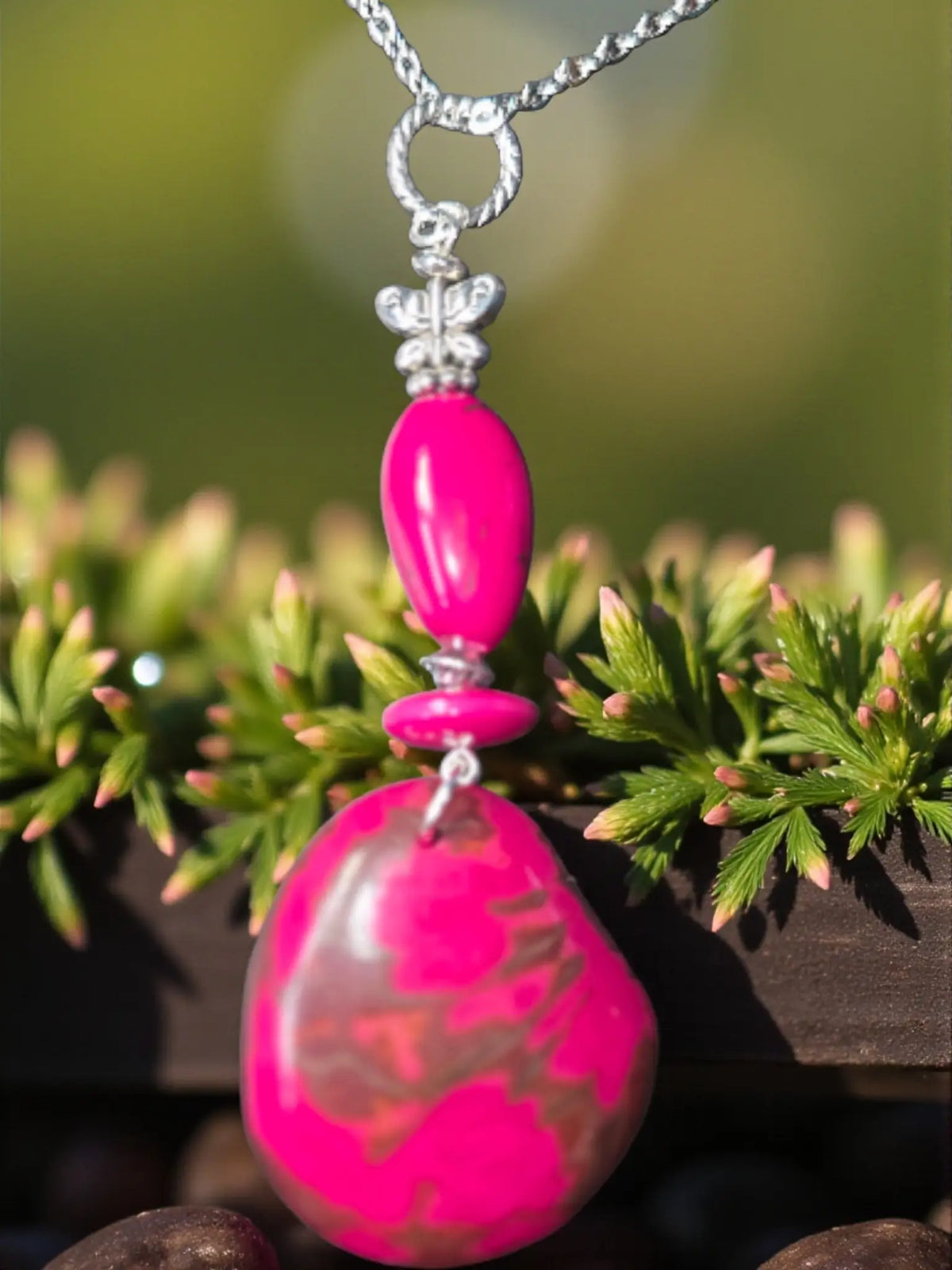 Hot pink natural live edge tagua butterfly necklace with vibrant handmade tagua mixed media pendant on silver chain