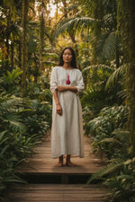A flowing off-white linen dress paired with a handmade tagua mixed media hot pink pendant necklace vegan from the rainforest