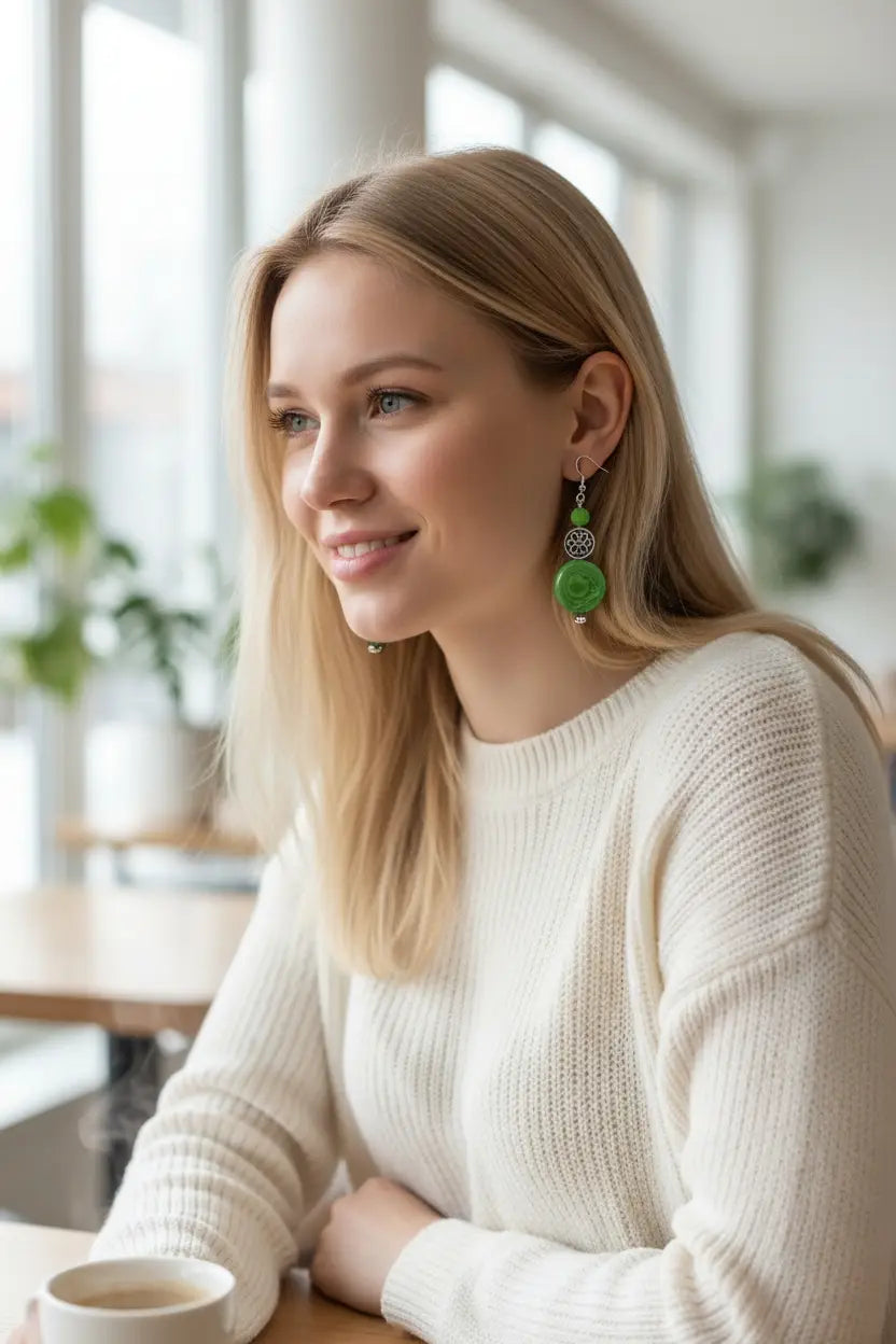 Green circular drop earrings with metallic accents made from rainforest tagua nut and celtic beads
