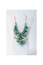 Layered turquoise and cream tagua necklace with leaf-shaped pendant and copper-toned chain in coastal aqua colors
