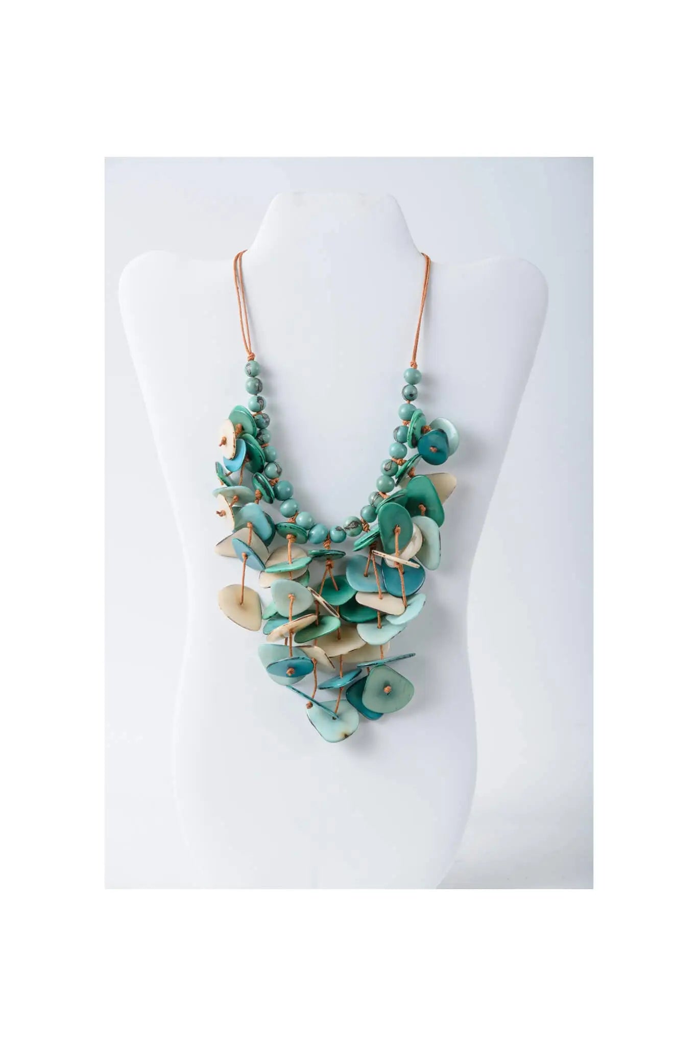 Layered turquoise and cream tagua necklace with leaf-shaped pendant and copper-toned chain in coastal aqua colors