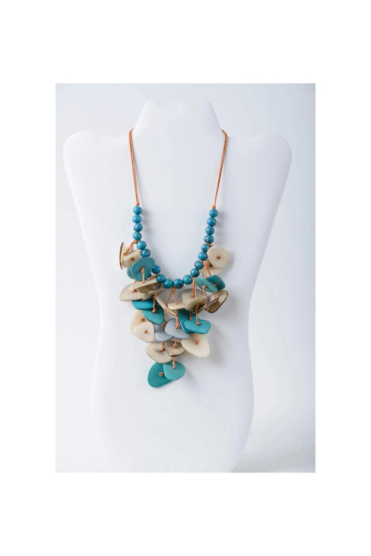 Teal and cream layered tagua necklace with wooden disc charms in coastal aqua color for versatile wear