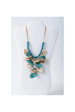 Teal and cream layered tagua necklace with wooden disc charms in coastal aqua color for versatile wear
