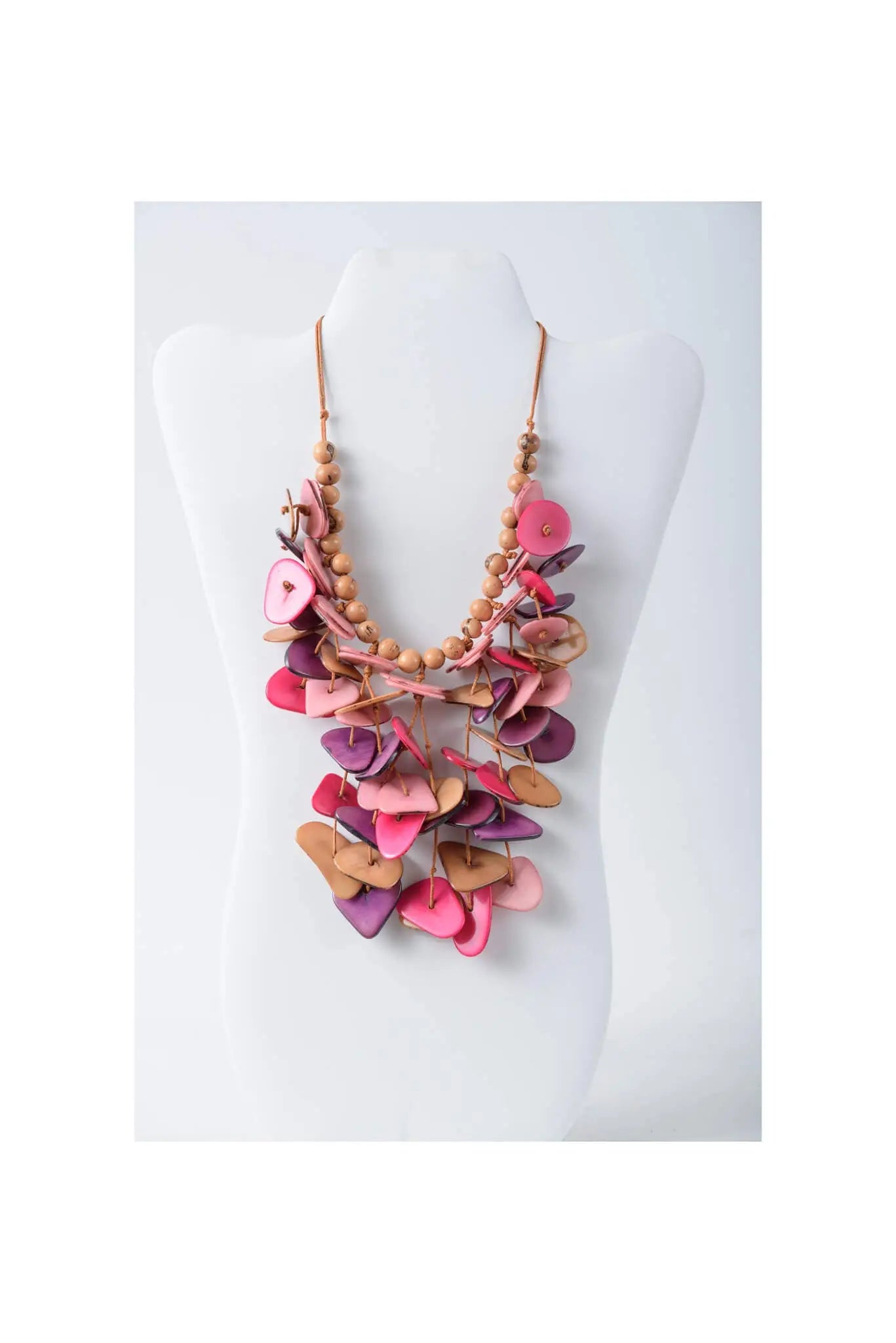 A vibrant ivy cascading tagua necklace in assorted coastal aqua colors with hand-cut wooden slices and natural beads