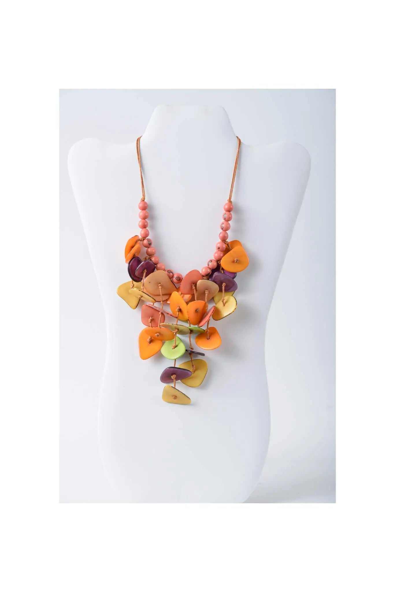 Vibrant ivy cascading tagua necklace with handcrafted wooden leaf pendants in orange purple and lime green on coral beads