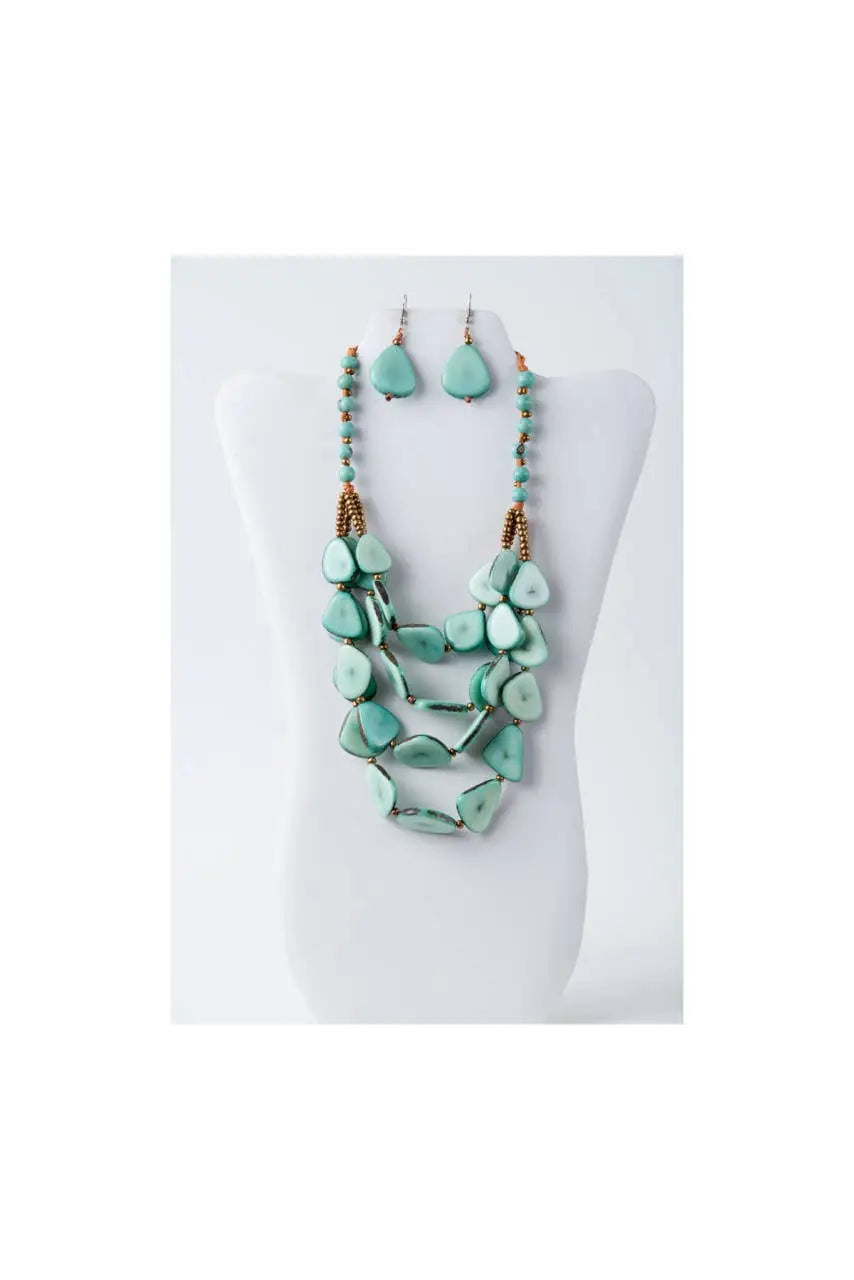 Jess multistranded organic tagua necklace and earrings with turquoise stones and gold-toned accents in actual colors