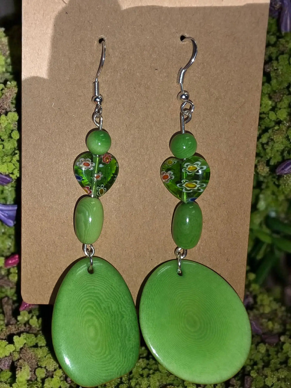 Kelly green swirly grain tagua earrings with glossy heart and oval shapes featuring floral patterns