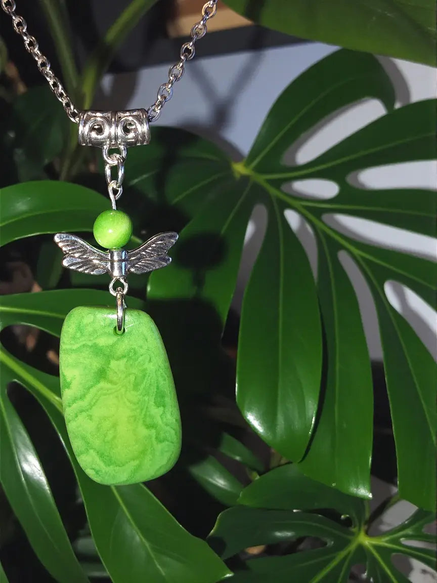 Green jade pendant necklace with silver-toned owl clasp, green bead, and angel wing charm eco-friendly design
