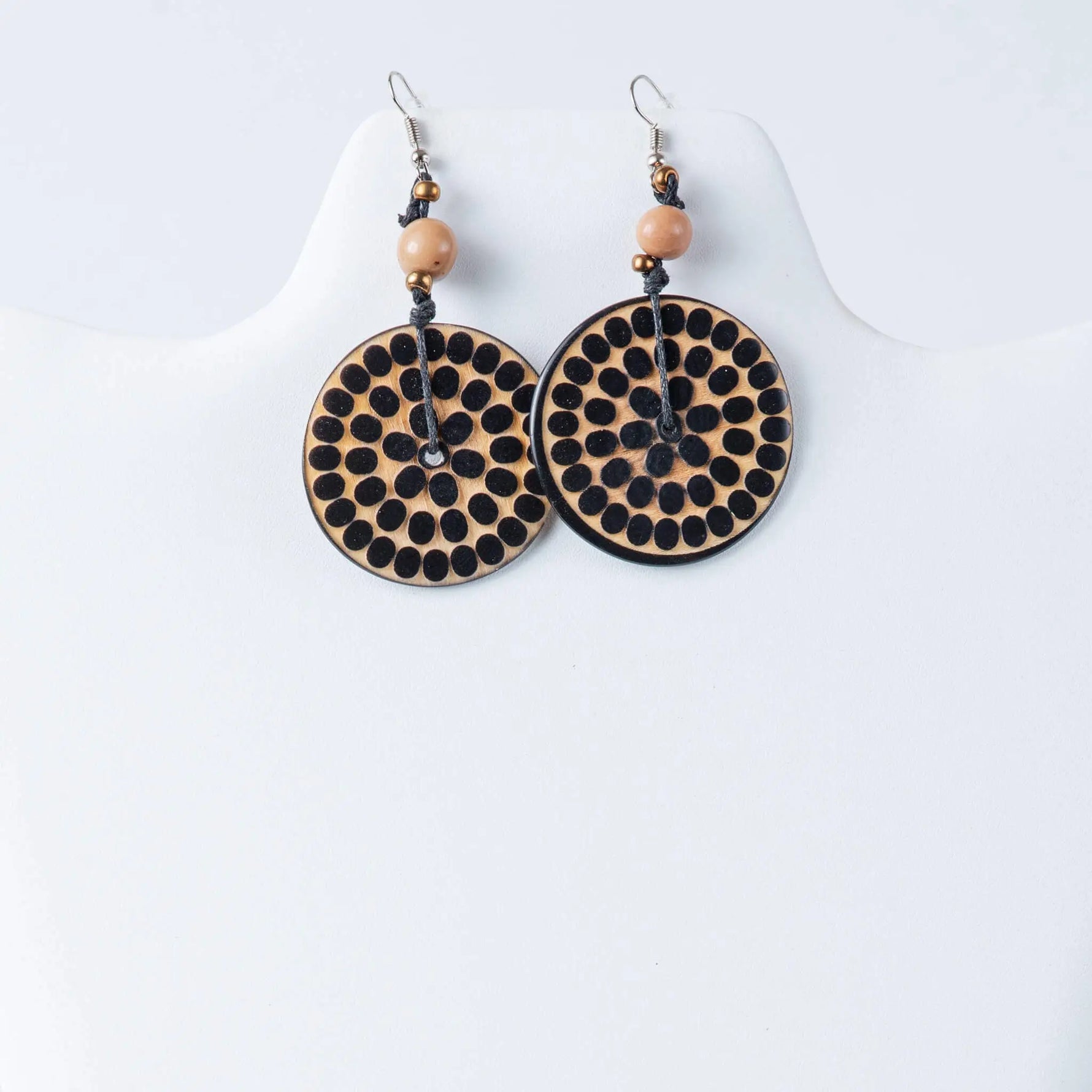 Circular natural tan wooden Lana eco-chic engraved tagua earrings with black dot pattern peach beads and silver hooks