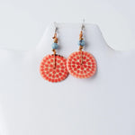 Coral-colored circular lana eco-chic engraved tagua earrings with dotted pattern light blue beads and gold-toned accents